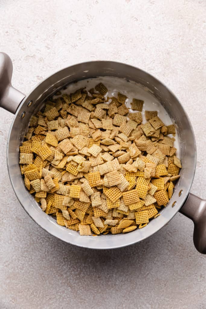 Chex cereal added to a pan of melted marshmallows.