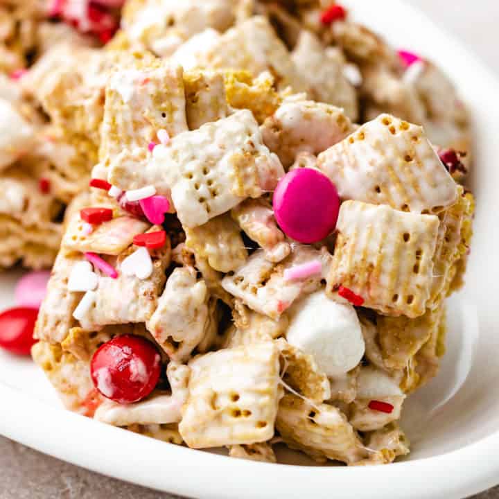 Close up view of valentine's chex cereal bars on a white dish.