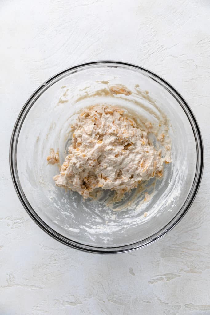 Biscuit dough in a glass bowl.