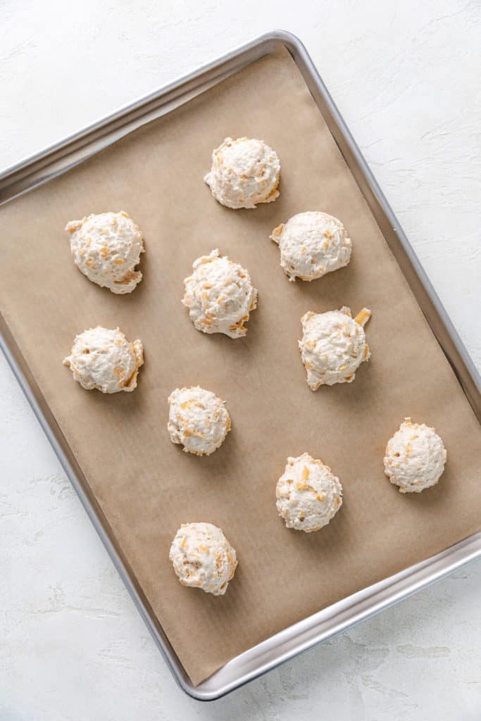 Biscuit dough on a baking sheet.