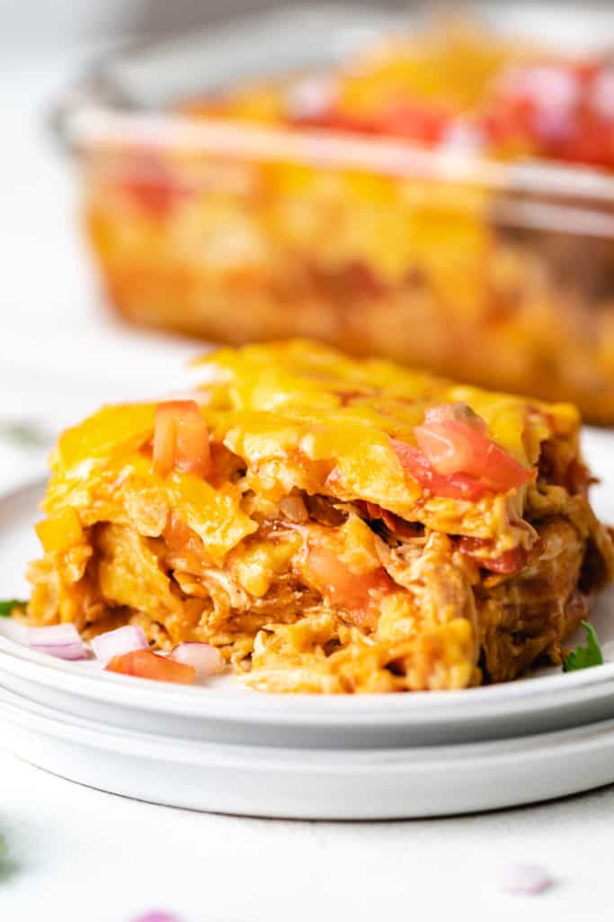 Cheesy chicken tortilla bake on gray plates.