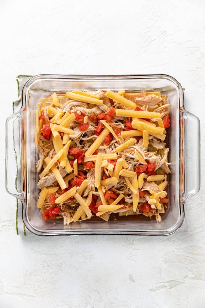 Cheese, chicken, cheese, and Rotel in a pan.