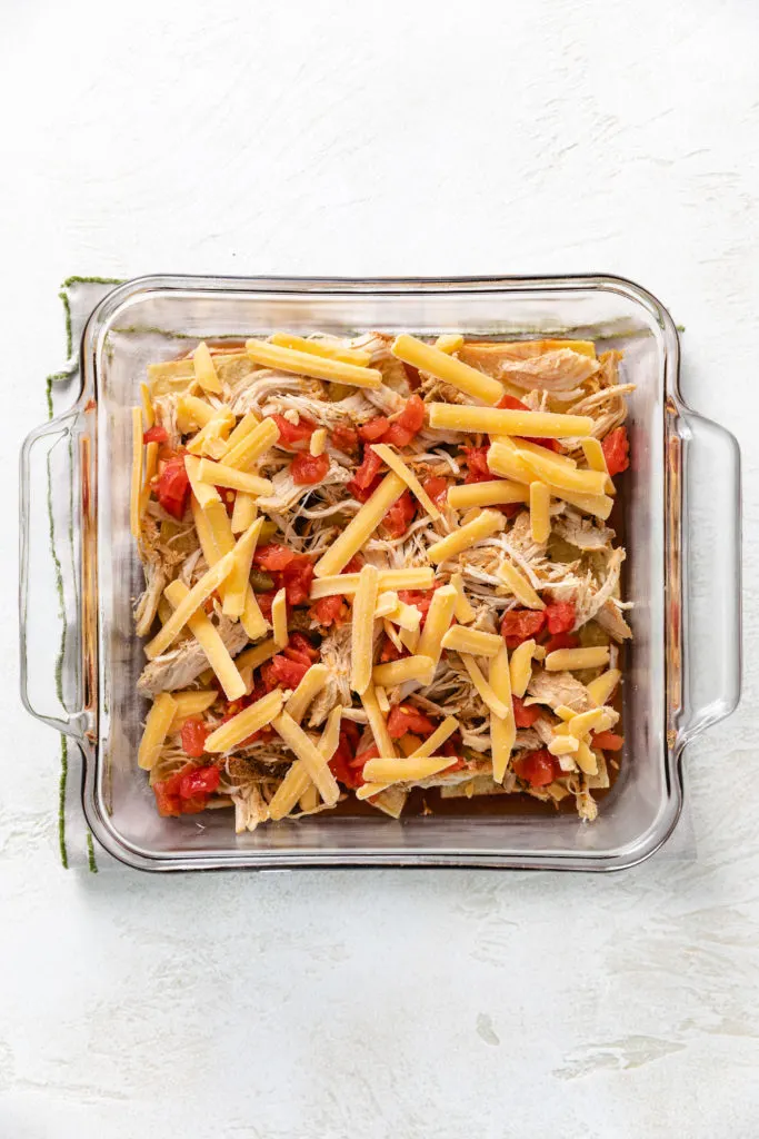 Cheese, chicken, cheese, and Rotel in a pan.
