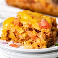 Slice of chicken enchilada casserole on a plate.