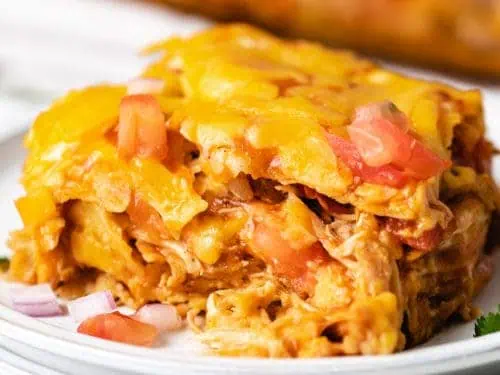 Slice of chicken enchilada casserole on a plate.