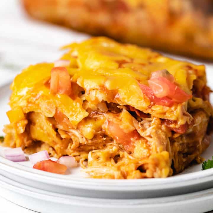 Slice of chicken enchilada casserole on a plate.