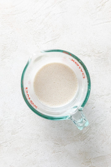 Milk and flour mixed in a measuring cup.