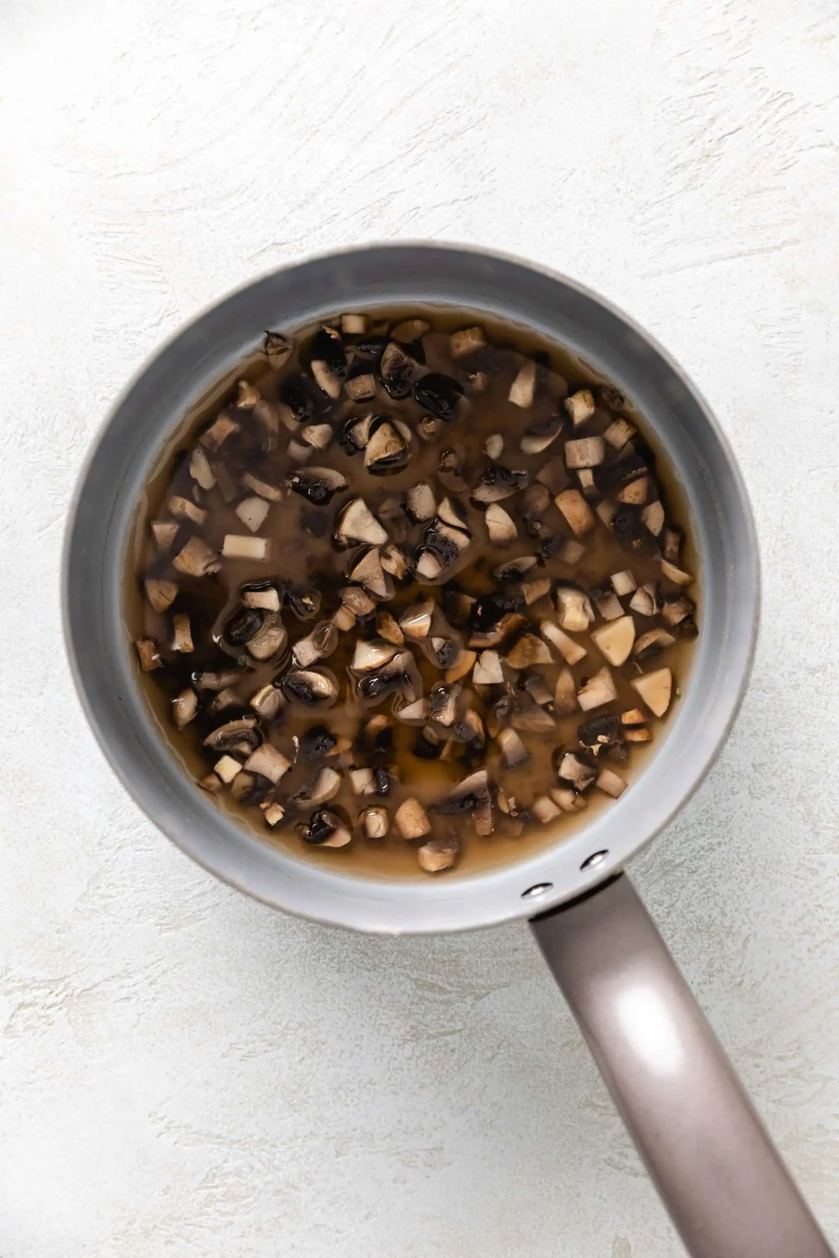 Mushrooms cooked down in broth.