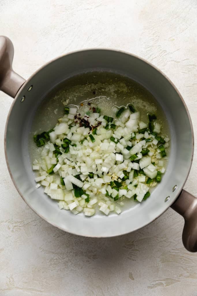 Onions, jalapenos, garlic, and red pepper flakes cooking in butter.