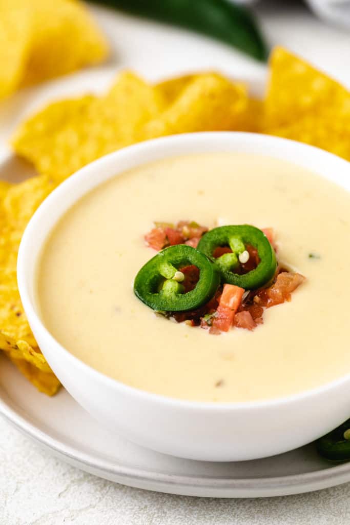 Side view of melted yellow cheese in a bowl.