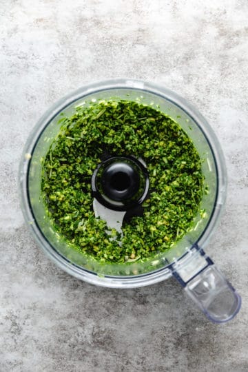 Basil, garlic, cheese, and pine nuts pulsed in a food processor.