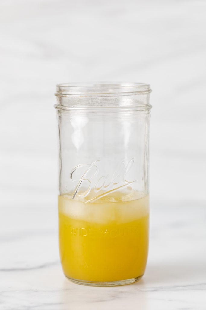 Pineapple juice and ice in a jar.