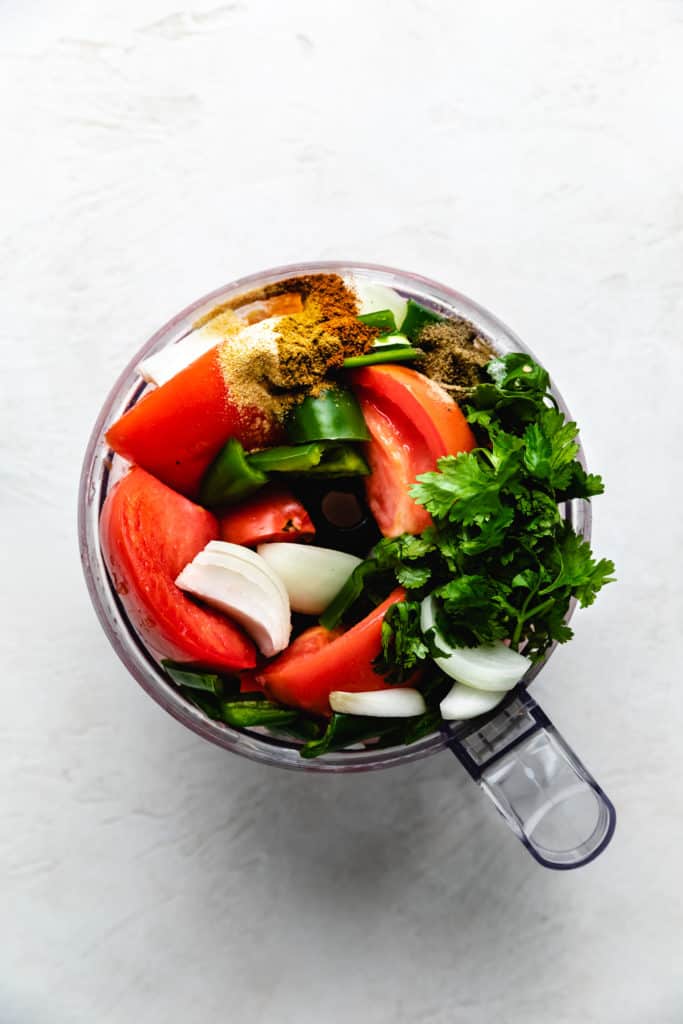 Ingredients for salsa in a food processor.