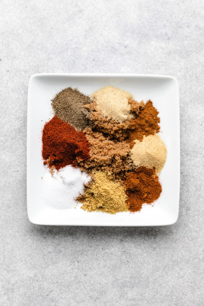 Ingredients for a seasoning rub on a plate.