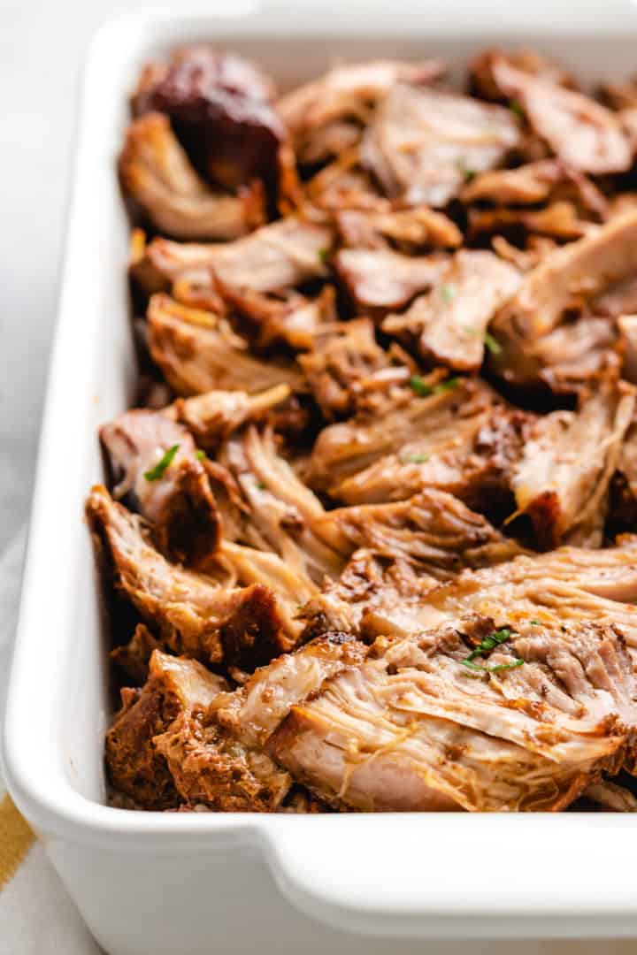 White baking dish filled with shredded country style ribs.