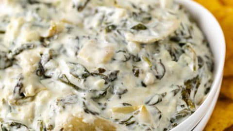 White bowl filled with spinach dip.