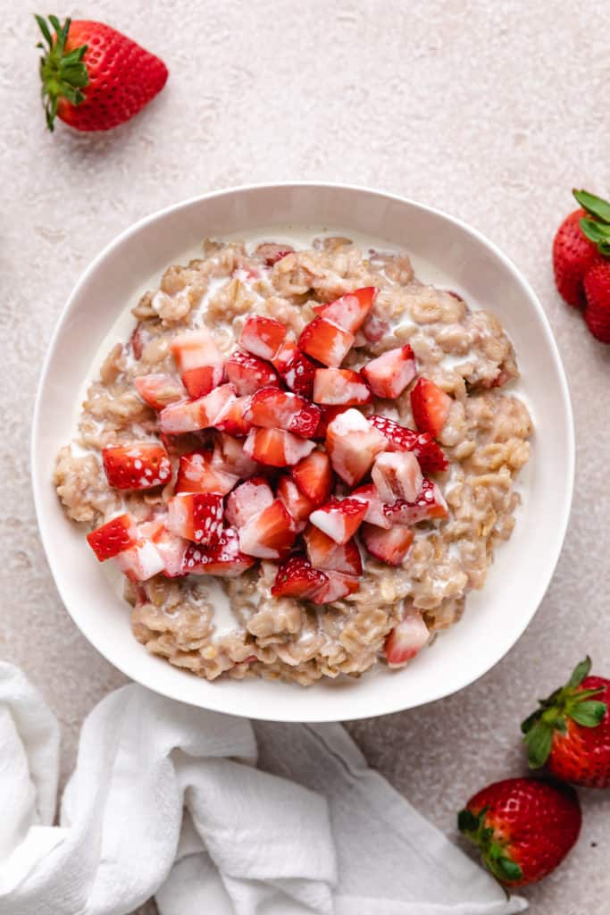 Top down view of a bowl of strawberries and cream oatmeal.