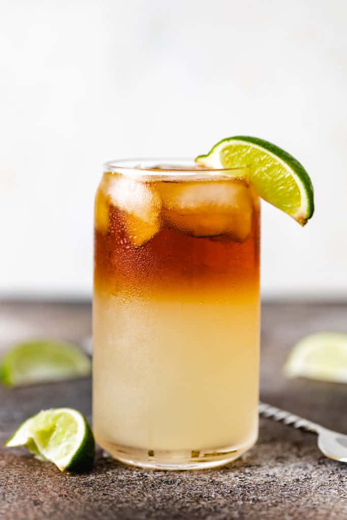 Layered rum and ginger beer drink in a glass.