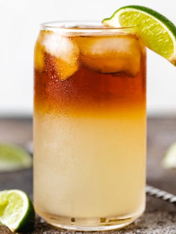 Side view of a lime wedge on a ginger beer drink.