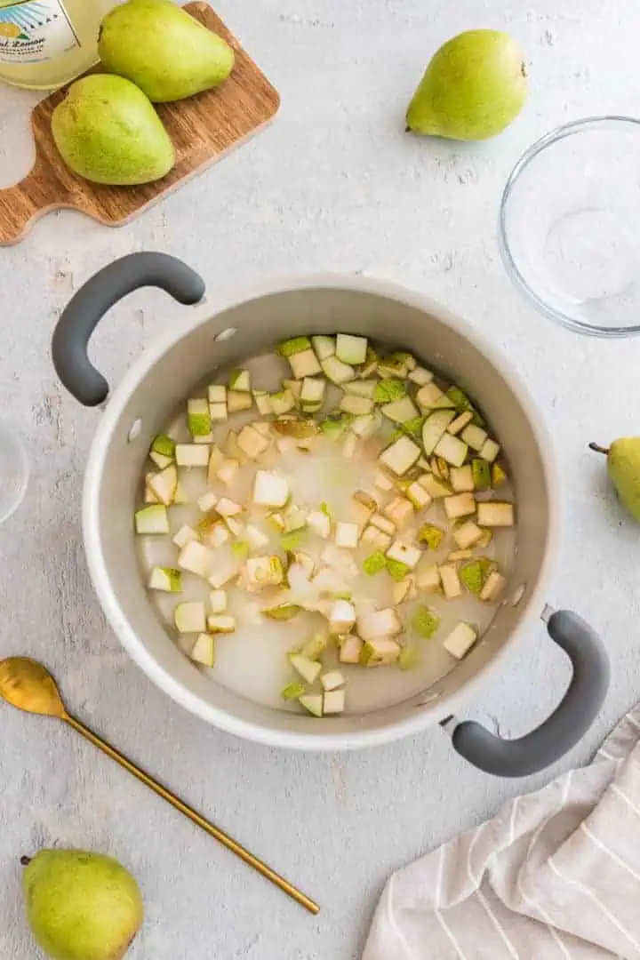 Pears, sugar, and water in a pan.