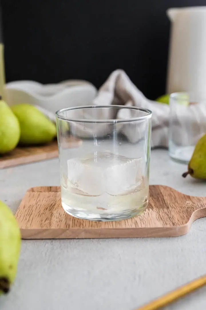 Cup with ice and ginger pear simple syrup.