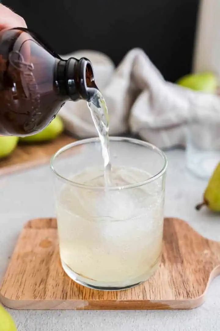 Ginger beer being poured into a glass.