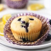 Close up view of a gluten free muffin on a paper liner.