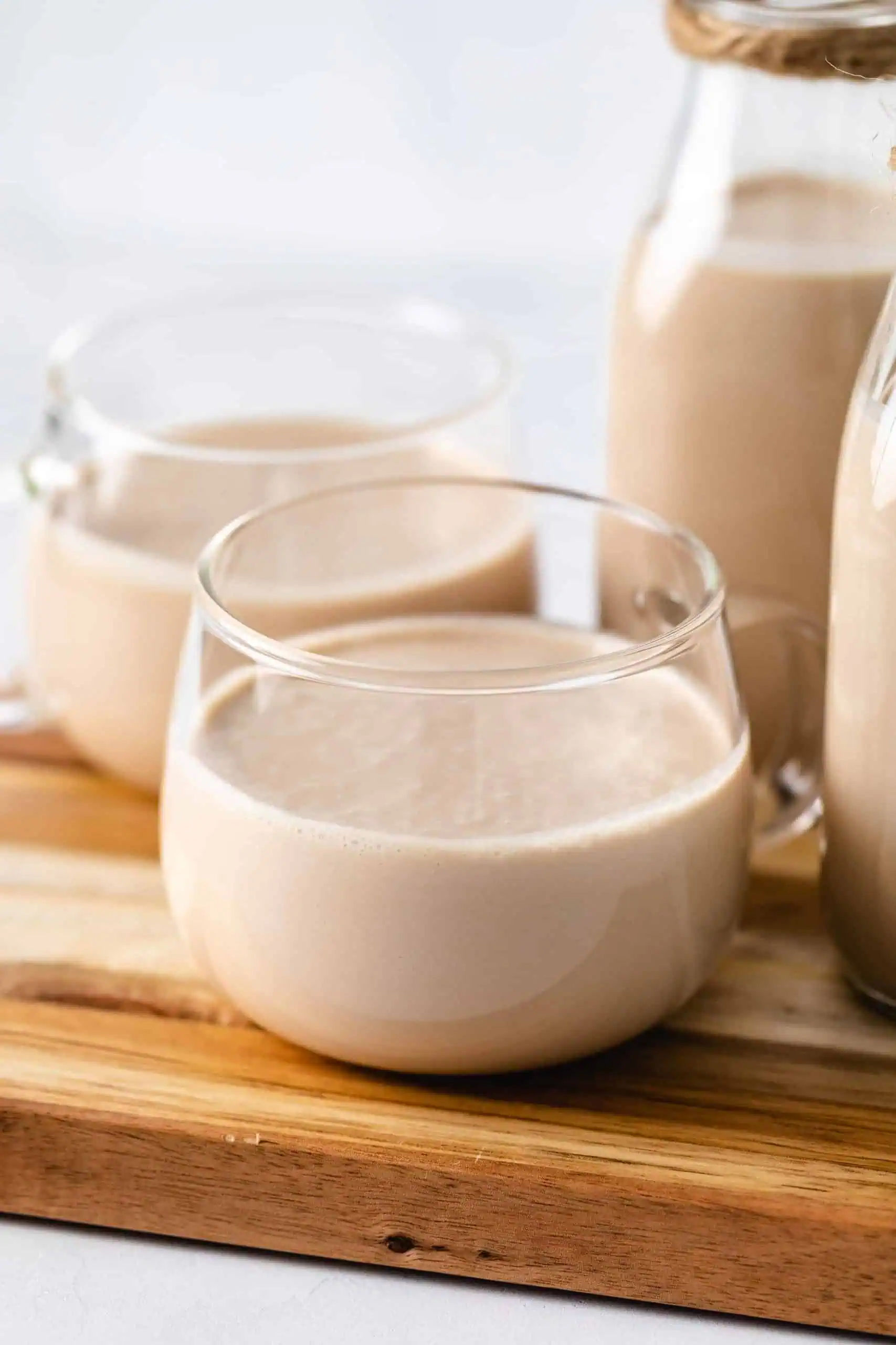 Cups of bailey's on a cutting board.