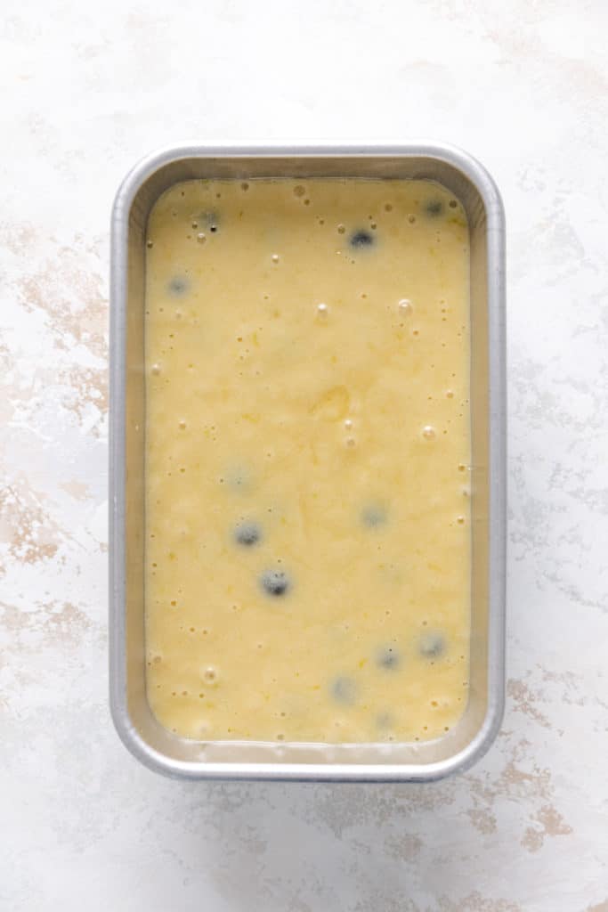 Bread batter poured into a loaf pan.