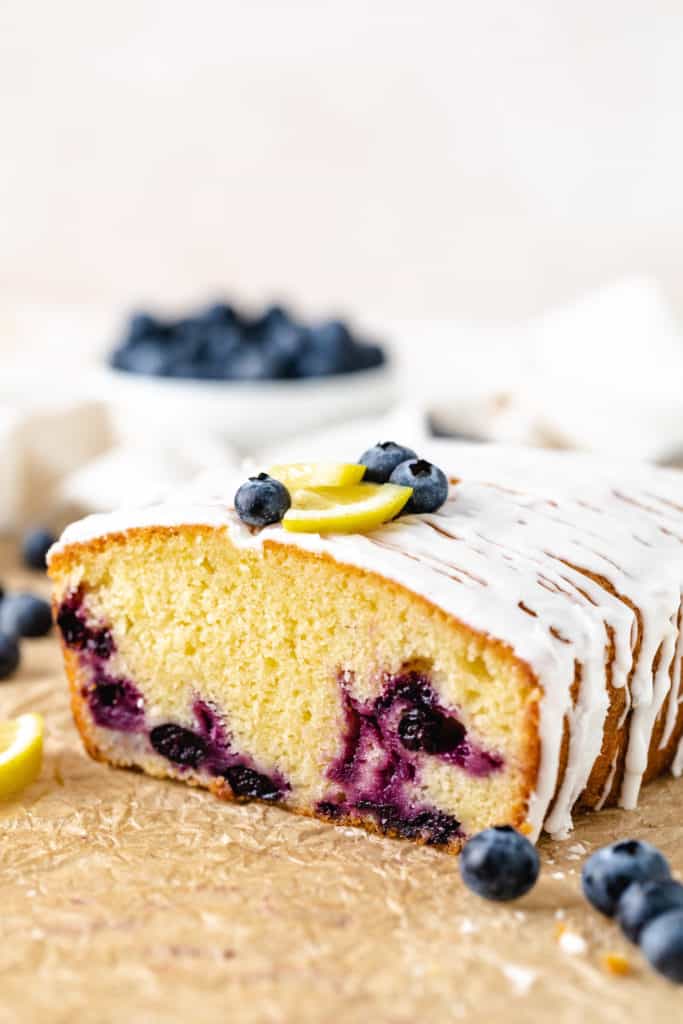 Side view of a loaf of lemon bread with blueberries.