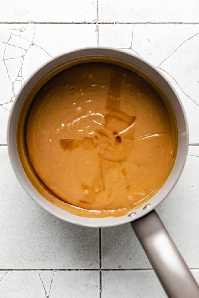 Melted peanut butter, honey, and vanilla in a saucepan.
