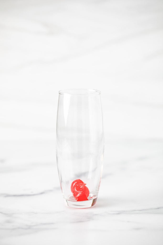 Maraschino cherries in a glass.