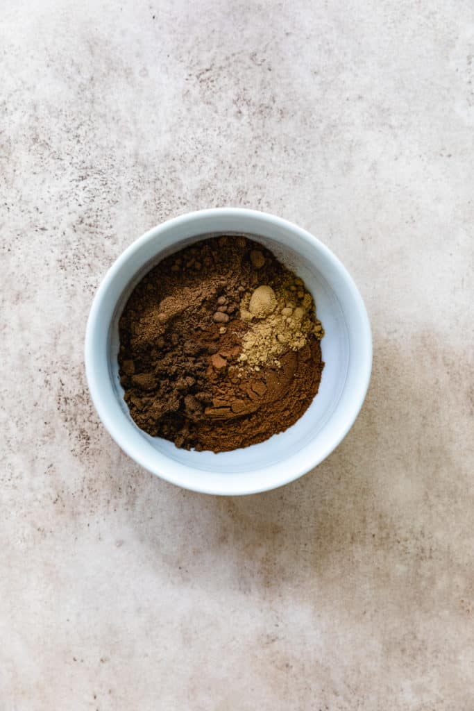 Cinnamon, nutmeg, ginger, and allspice in a bowl.