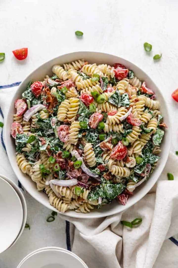 Large bowl filled with blt pasta salad and ranch dressing.