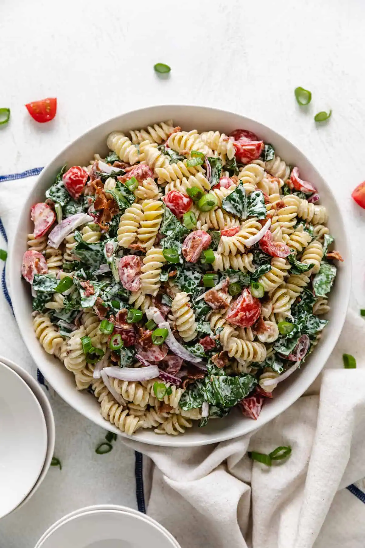 Large bowl filled with blt pasta salad and ranch dressing.