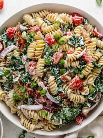 Top down view of a mixing bowl filled with BLT pasta salad.