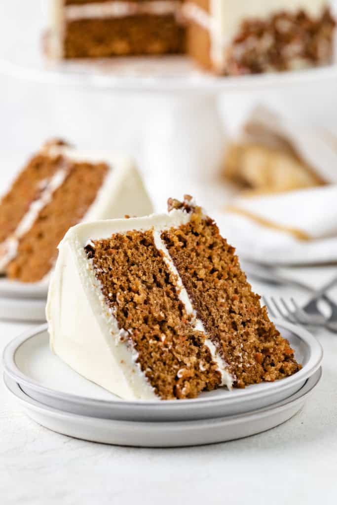 Carrot cake on a stack of plates.