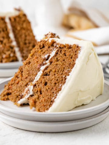 Slices of cake with cream cheese frosting.