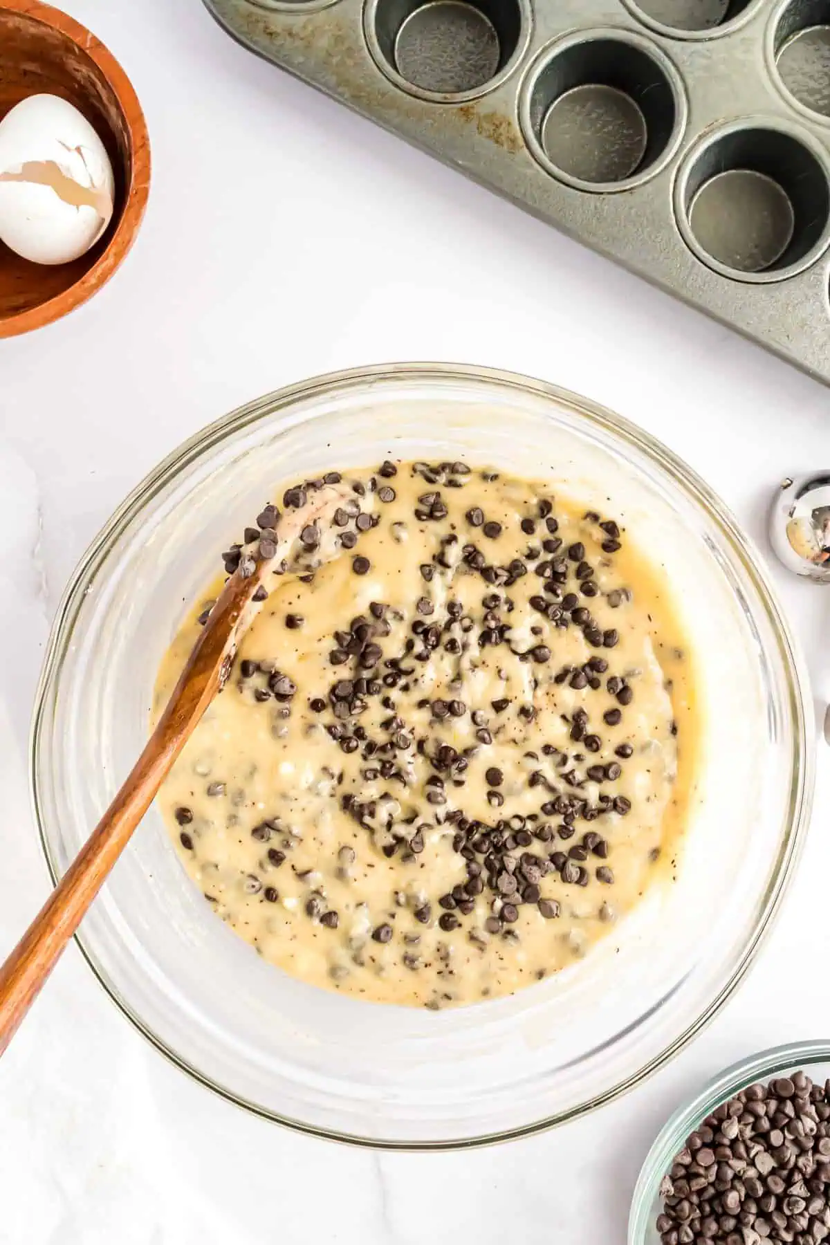 Chocolate chip muffin batter in a glass bowl.