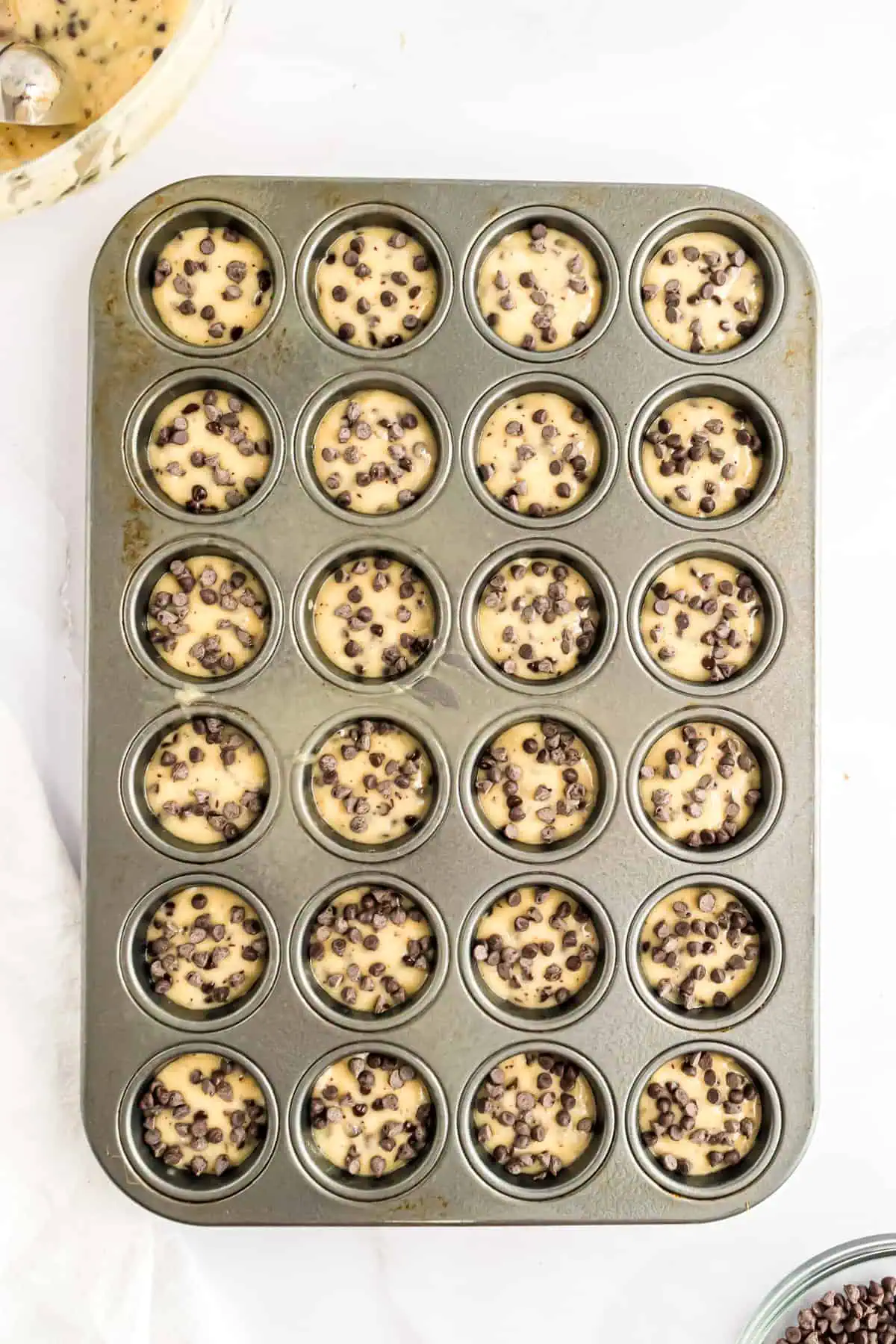 Unbaked mini muffins in a pan.
