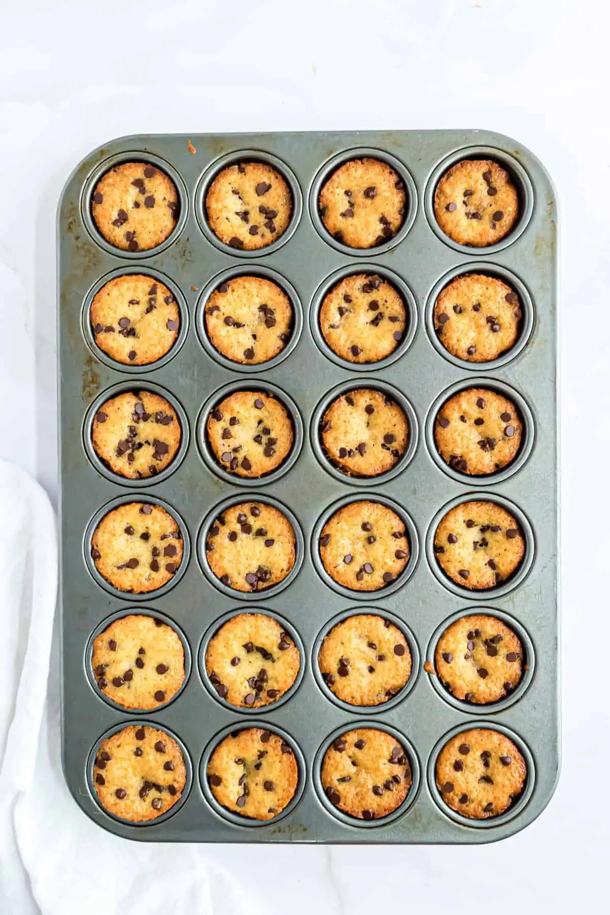 Mini chocolate chip muffins in a pan.