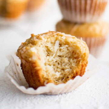 Bite taken out of a coconut muffin.