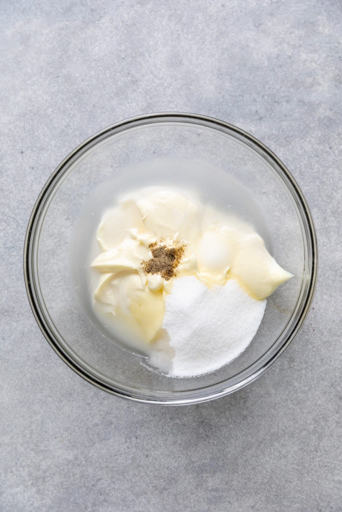 Mayo, sugar, vinegar, salt and pepper in a bowl.