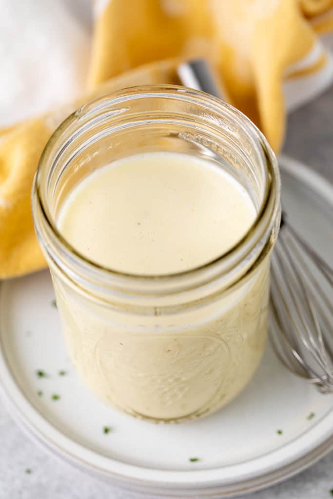 Top down view of a jar of creamy dressing used for coleslaw.