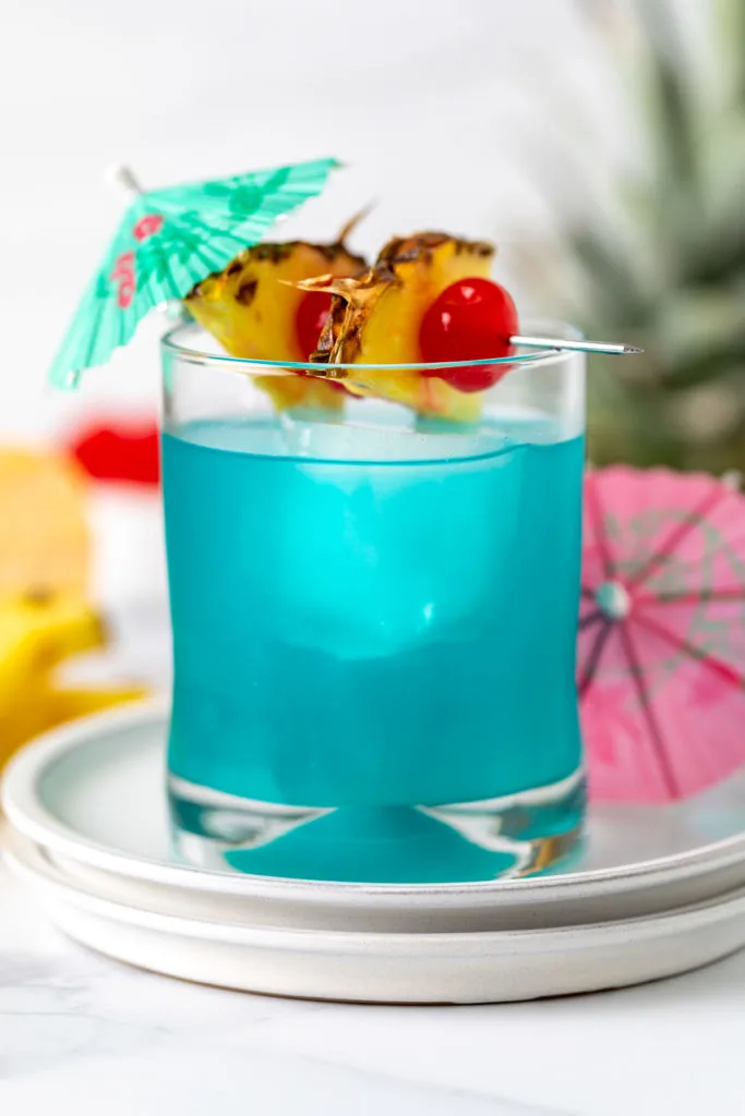 Blue curacao cocktail with garnishes.
