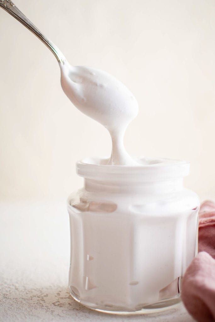 Spoon scooping marshmallow cream.