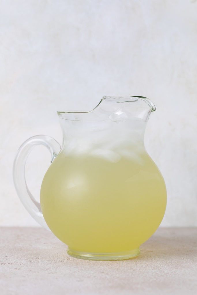 Glass pitcher filled with hard lemonade.