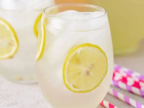 Close up view of tequila lemonade with lemon.