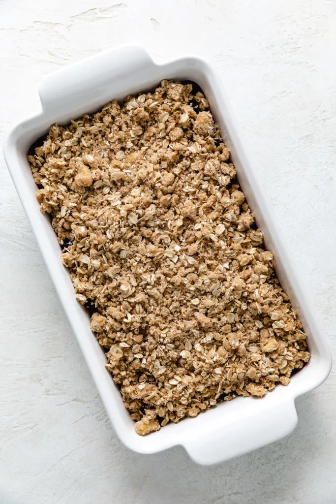 Crumble topping placed on a crisp.