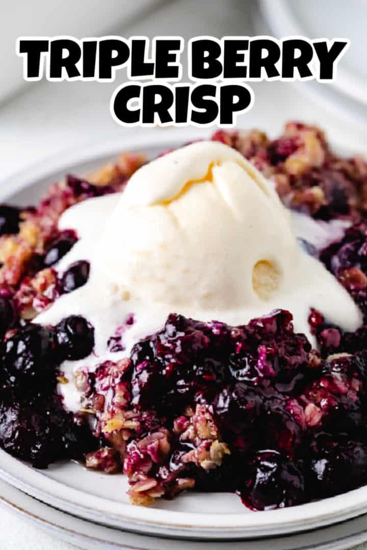 Close up view of a stack of plates holding fruit crisp and ice cream.